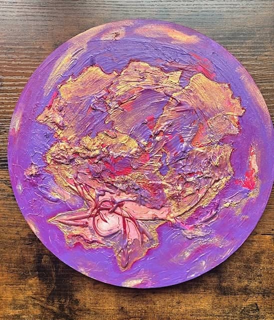 Hibiscus, Mixed media relief, 2026, by Anujalika. A round panel with a thick purple, pink and gold relief resembling a flower.