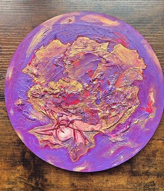 Hibiscus, Mixed media relief, 2026, by Anujalika. A round panel with a thick purple, pink and gold relief resembling a flower.